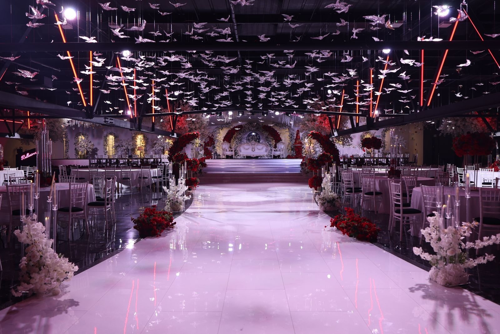 The Bellissima Suite — chandeliers above a lit aisle