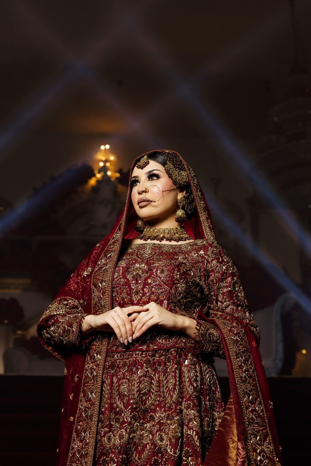Bride in deep red bridal wear at The Excellency