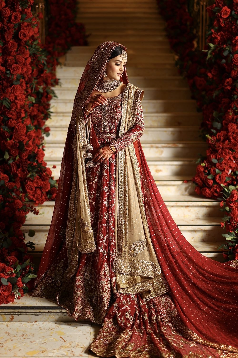 Bride on the red-rose staircase at The Excellency
